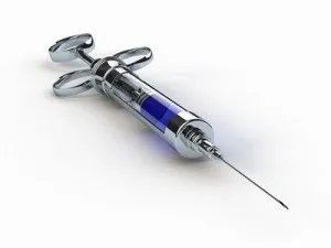 Metal glass syringe isolated on white